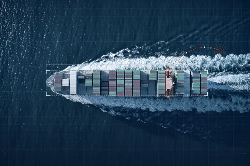 Aerial view of a container ship outlined as a digital twin with a data link to shore